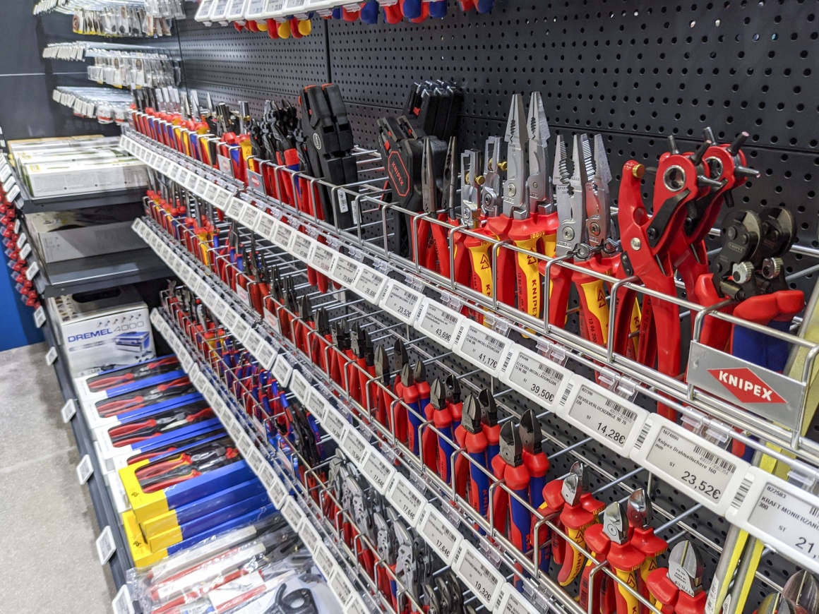 A goods shelf in a consumer electronics store with electronic price tags...