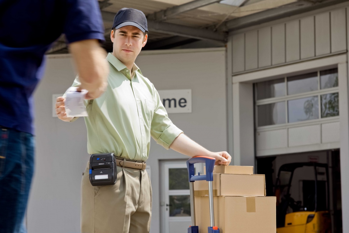 A logistics employee hands over a receipt