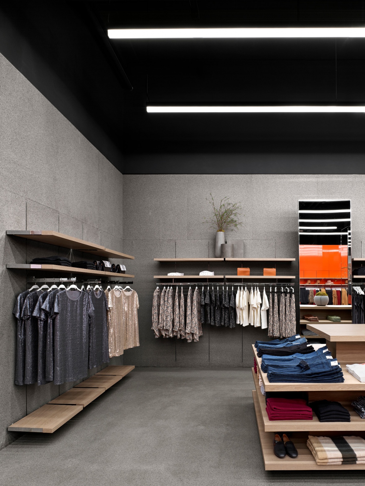 Interior of a flagship fashion store with grey walls and floor...
