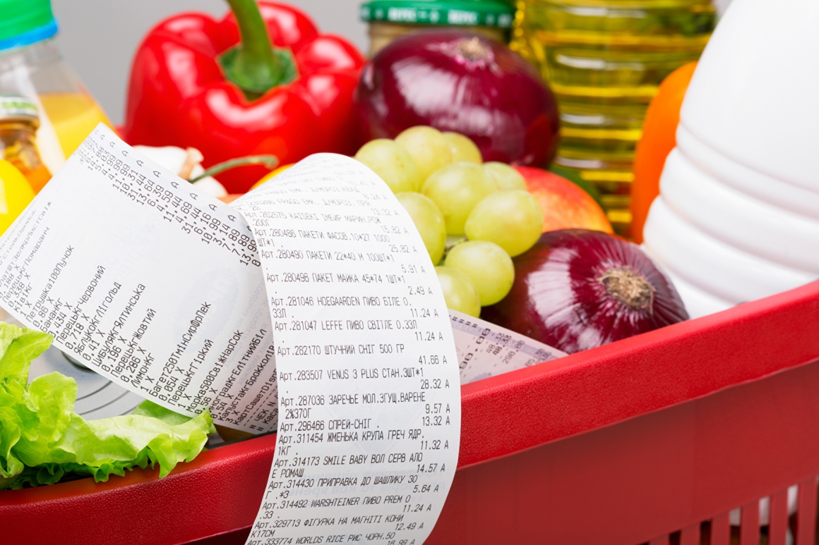 A shopping cart full of groceries and a long receipt...