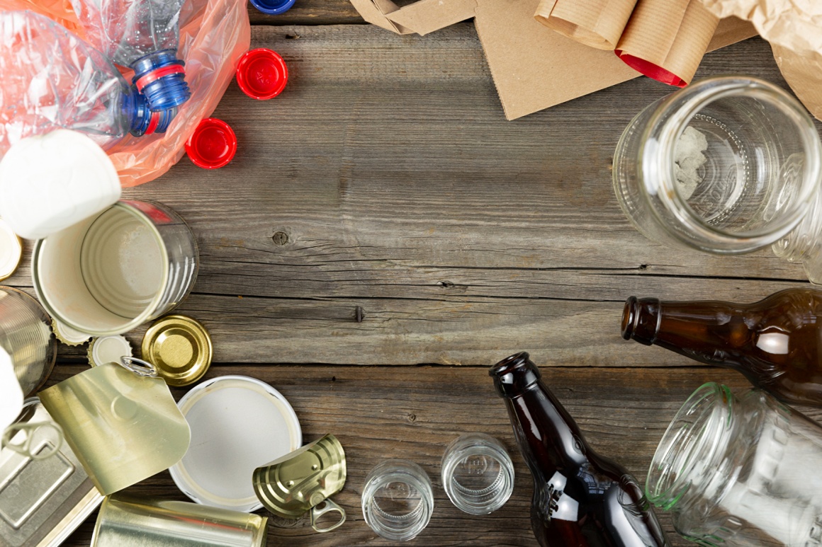 Several different types of packaging, bottles, glasses, bags, tin cans, lying...