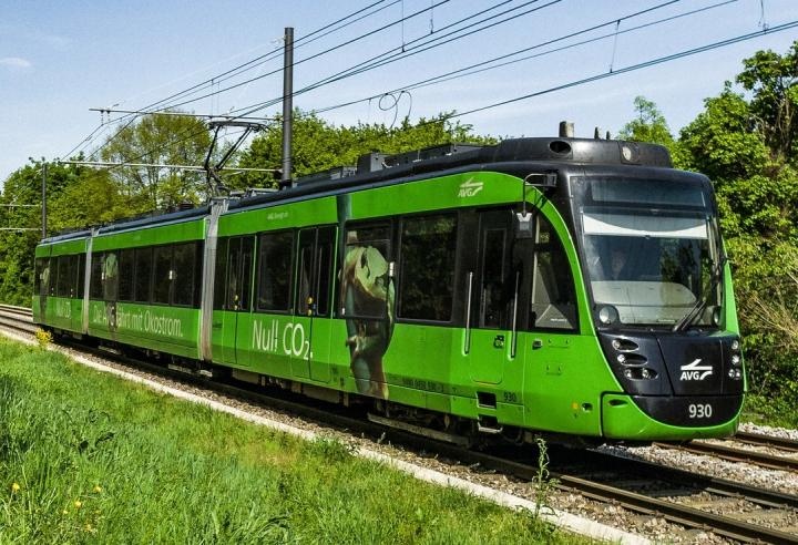 A green tram of the Albtal-Verkehrs-Gesellschaft in the countryside...