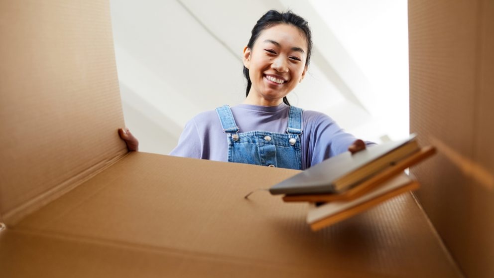 Woman puts books in a box