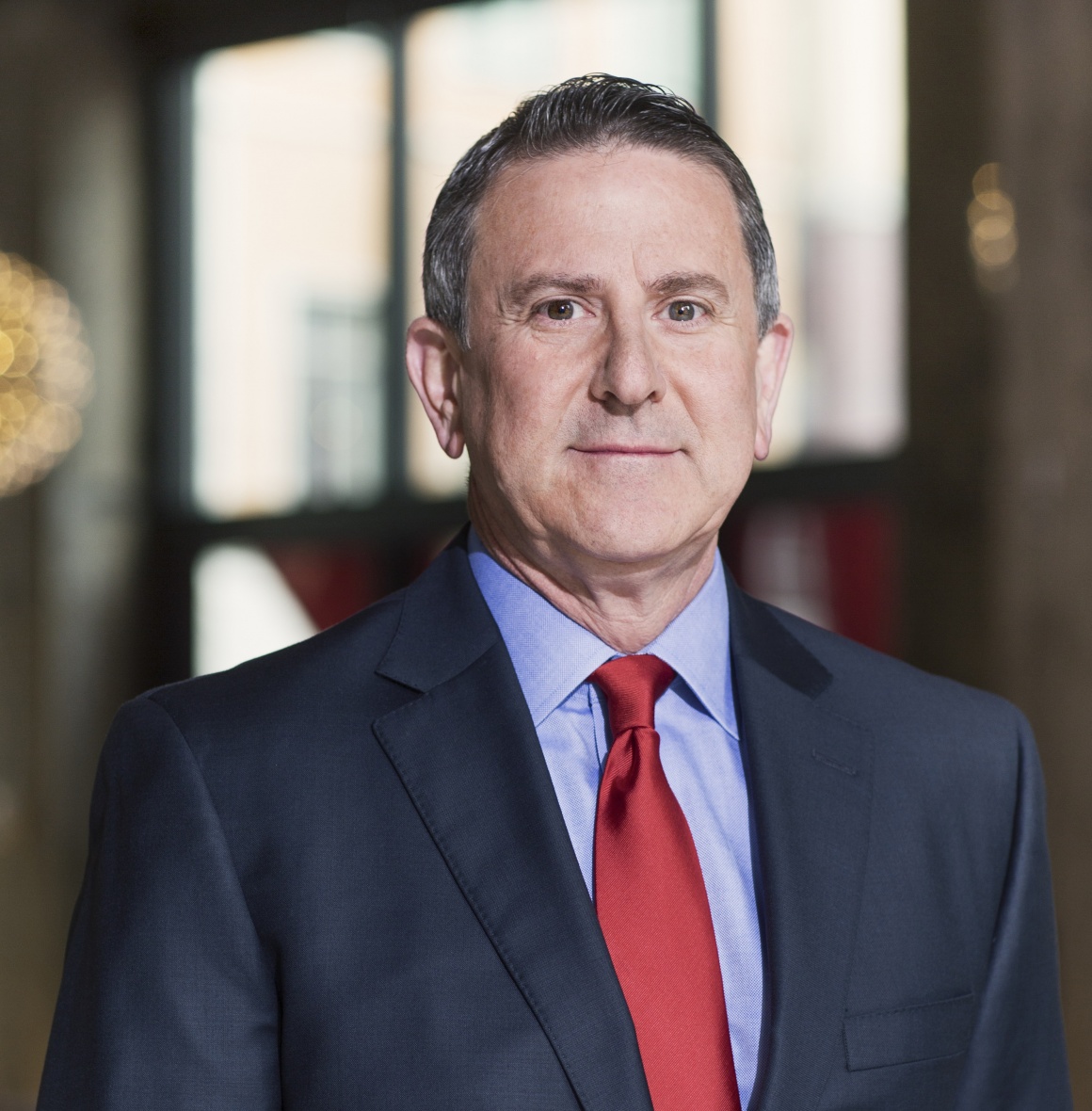 Man in suit smiles at the camera